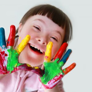 Cute,Little,Down,Syndrome,Girl,With,Painted,Hands.